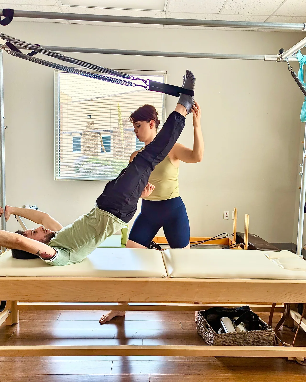 A client working on the Cadillac apparatus with hands-on guidance at La Luz Body Align in Albuquerque