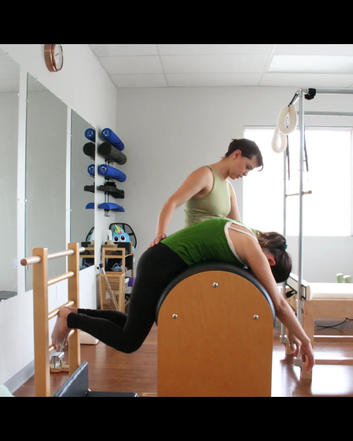 A client balancing through a controlled movement on the step barrel at La Luz Body Align